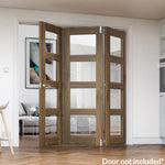Lifestyle prefinished walnut bifold frame kit with glazed folding doors in a modern room