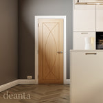 Lifestyle oak Amalfi solid internal door in a light room with neutral walls and natural flooring