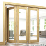 Lifestyle unfinished oak bifold frame kit installed with glazed folding doors in a bright room