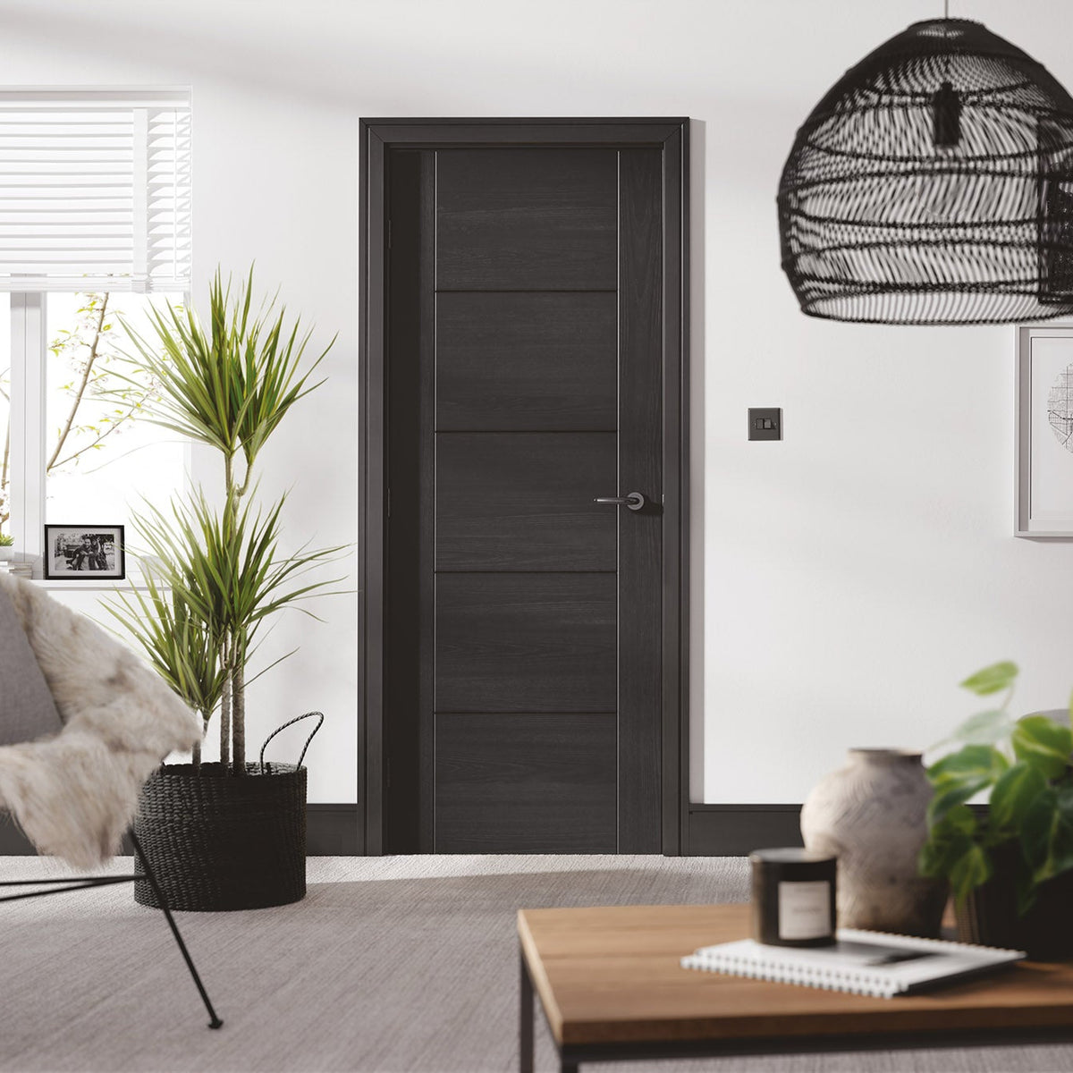 Lifestyle charcoal black Vancouver five-panel internal door installed in a stylish room