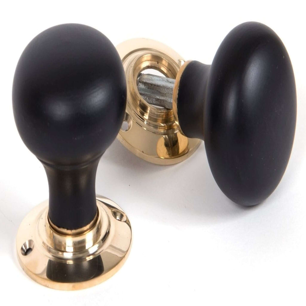 Product ebonised wooden bun period door knob on white background