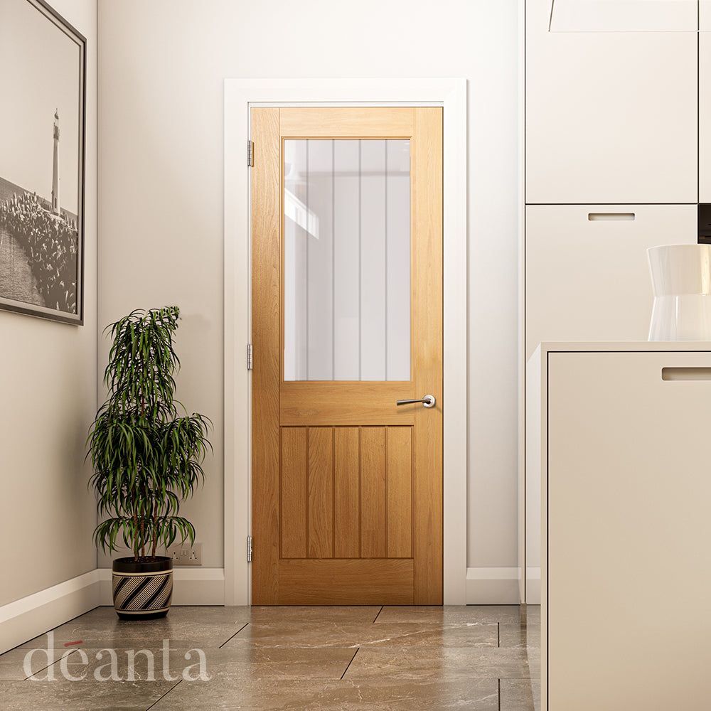 Lifestyle oak Ely one-light clear glazed internal door in a bright room with natural wood tones