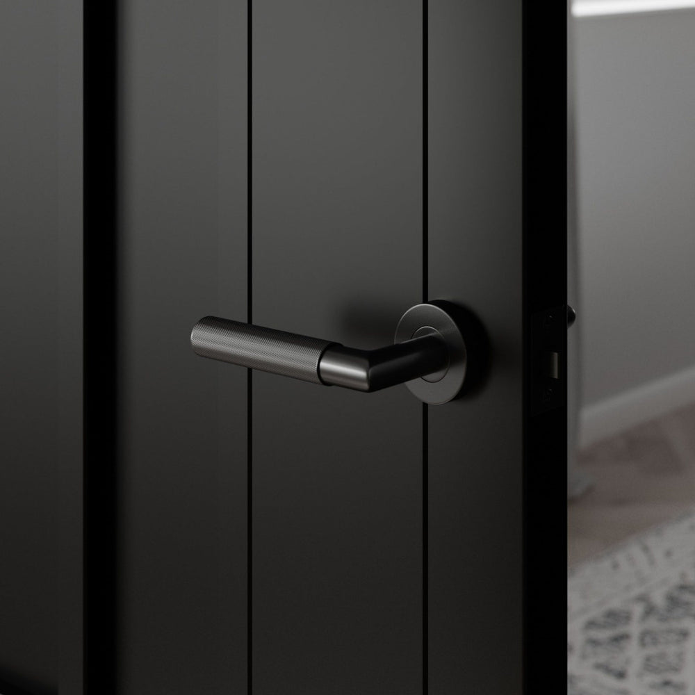 Lifestyle Arlington black standard latch pack handle installed on a modern door
