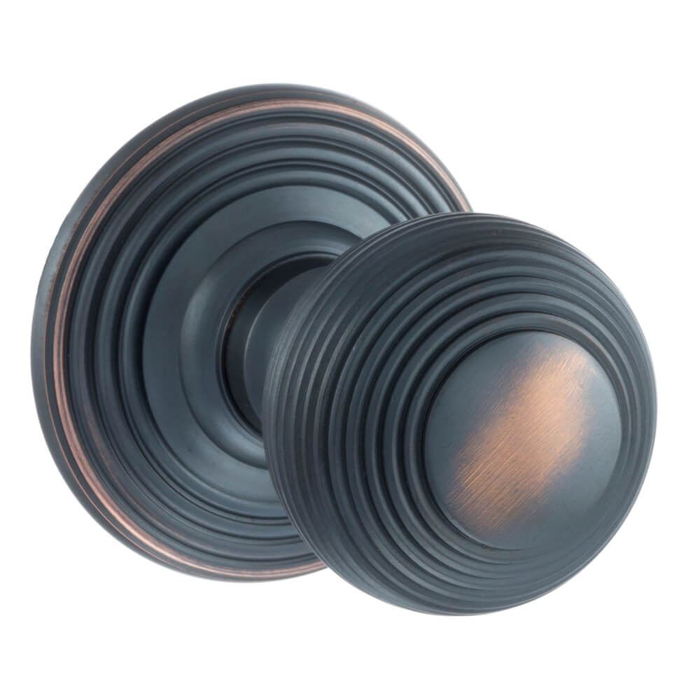 A pair of round antique copper door knobs with concentric ring detailing, shown on a plain white background.