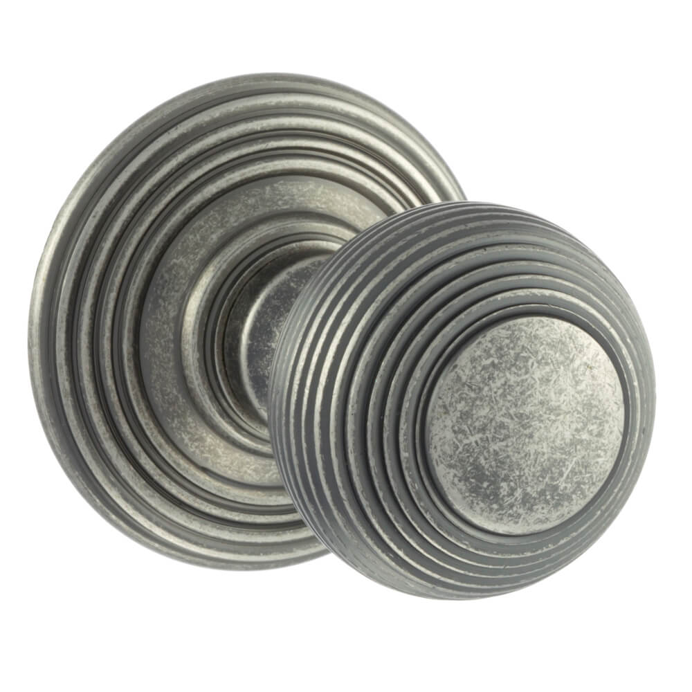 A pair of round distressed silver door knobs with concentric ring detailing, shown on a plain white background.