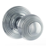 A pair of round silver door knobs with concentric circular grooved detailing, shown on a plain white background.