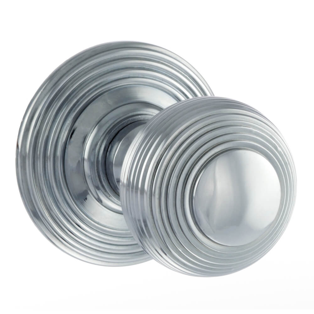 A pair of round silver door knobs with concentric circular grooved detailing, shown on a plain white background.