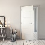 Lifestyle white primed Pamplona solid internal door in a bright room with pale walls
