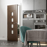 Lifestyle walnut Pamplona clear glazed internal door in a bright room with warm wood tones