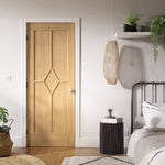 Lifestyle prefinished oak Reims five-panel diamond FD30 fire door in a modern hallway