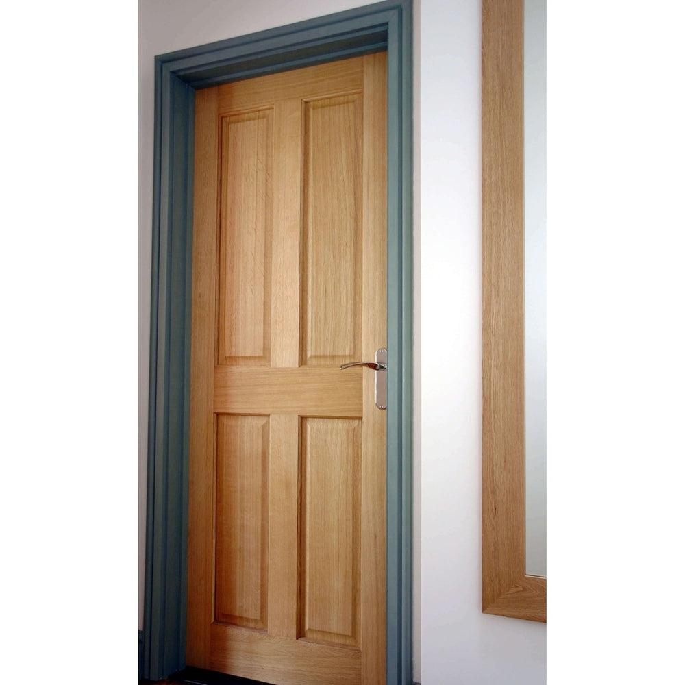 Lifestyle Victorian four-panel oak veneer door installed in a room