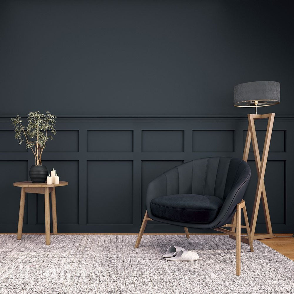 Lifestyle dark Hampton wall panelling installed behind a lounge chair