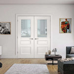 Lifestyle Windsor white primed FD30 glazed fire double doors in a living room